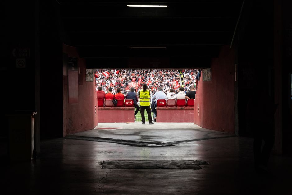 A dynamic stadium perspective through the tunnel showcasing engaged spectators during a game.