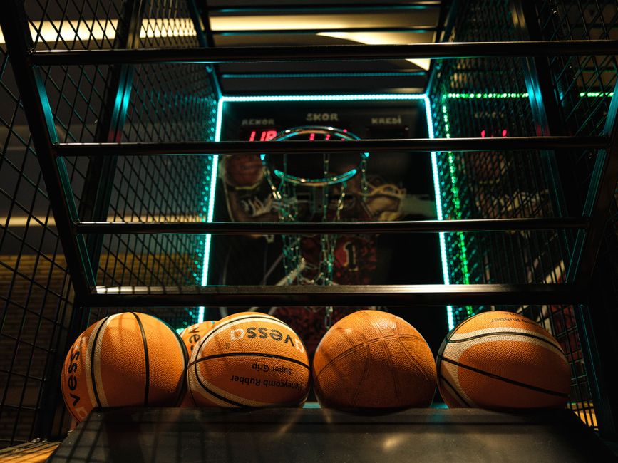 Close-up view of basketballs lined up for an arcade basketball hoop game.